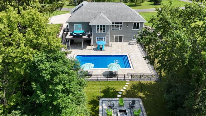 inground vinyl liner swimming pool Waukesha Wisconsin with diving board, basketball hoop, firepit